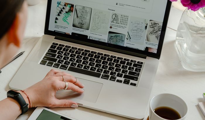 Creative work session featuring a woman using a tablet and laptop for design projects.